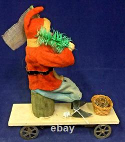 1930 Vintage Santa withTree on Moving Board withWind-up Mechanism & Christmas Flag