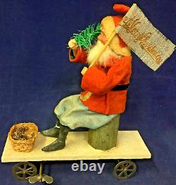 1930 Vintage Santa withTree on Moving Board withWind-up Mechanism & Christmas Flag