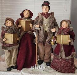 4 Christmas Carolers figurines with real clothing resin. The tallest 30 Rare