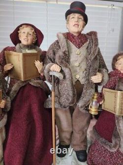 4 Christmas Carolers figurines with real clothing resin. The tallest 30 Rare