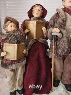 4 Christmas Carolers figurines with real clothing resin. The tallest 30 Rare