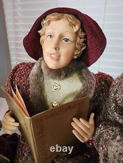 4 Christmas Carolers figurines with real clothing resin. The tallest 30 Rare