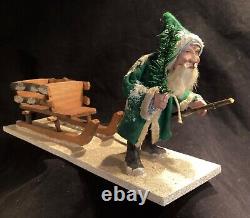 Antique German Christmas Green Coat Trudging Santa Claus pulling Sleigh