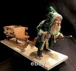 Antique German Christmas Green Coat Trudging Santa Claus pulling Sleigh