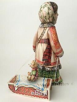 Collectible wooden Girl with a Teddy Bear sitting on a sled folk winter figurine