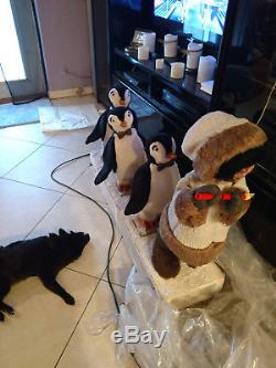 Harold Gale Eskimo playing flute with penguins following