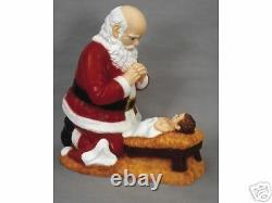 Kneeling Santa and Christ Child in Manger