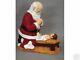 Kneeling Santa And Christ Child In Manger