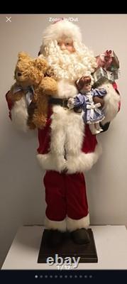 This is a life-sized decorative Santa Claus figure. The figure is shown