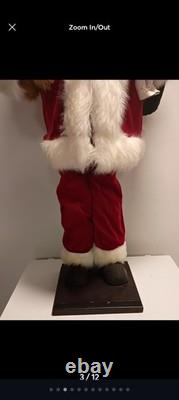 This is a life-sized decorative Santa Claus figure. The figure is shown