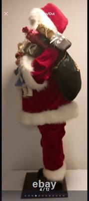 This is a life-sized decorative Santa Claus figure. The figure is shown