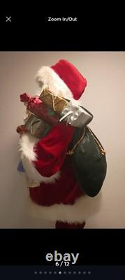This is a life-sized decorative Santa Claus figure. The figure is shown