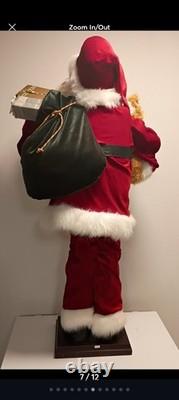 This is a life-sized decorative Santa Claus figure. The figure is shown