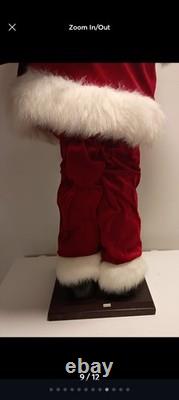 This is a life-sized decorative Santa Claus figure. The figure is shown