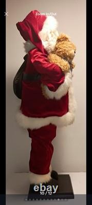 This is a life-sized decorative Santa Claus figure. The figure is shown