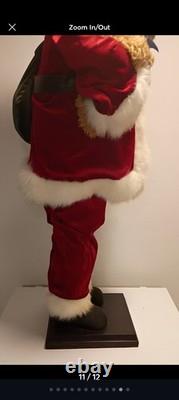 This is a life-sized decorative Santa Claus figure. The figure is shown